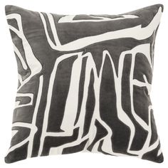 a black and white pillow with an abstract design on the front, sitting against a white background