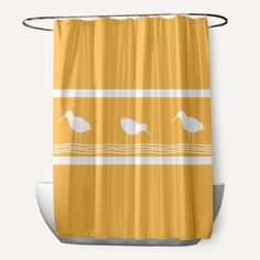 a yellow shower curtain with two birds on the water and one bird standing in the water