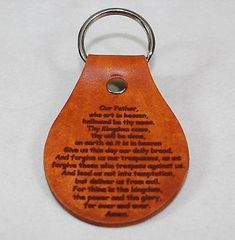 a wooden key chain with a poem engraved on the front and back side, hanging from a metal ring