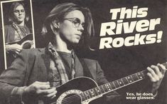 a man playing an acoustic guitar in front of a newspaper advertisement for the river rocks