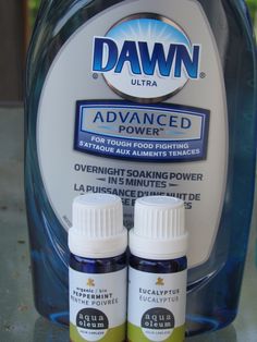 two bottles of dawn advanced power sit on a table next to an open bottle of liquid