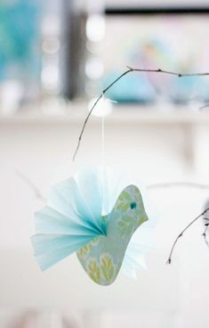 a bird ornament hanging from a twig