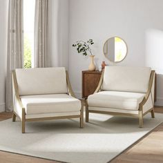 two white chairs sitting on top of a wooden floor next to a mirror and vase