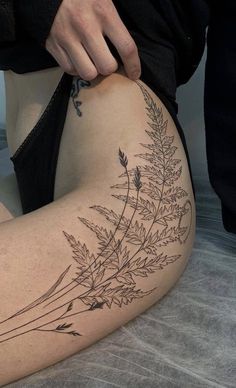 a person with a tattoo on their thigh