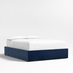 the bed is made up with white and blue sheets