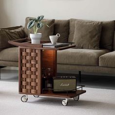 a living room with a couch, coffee table and other items on wheels in front of it