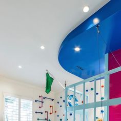 a child's playroom with climbing bars and toys