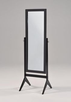 a black standing mirror on top of a wooden stand