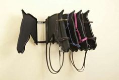 a horse's bridle is mounted to the wall with harnesses on it