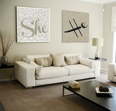 a living room with two couches, a coffee table and a painting on the wall