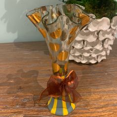 a glass vase sitting on top of a wooden table