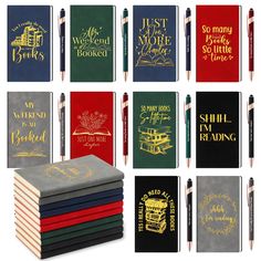 several different colored notebooks with gold lettering on them and one has a pen in the middle