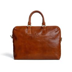 "Description: Discover the perfect blend of style and functionality with our handcrafted leather laptop bag. Crafted from full-grain, vegetable-tanned leather, this bag boasts a semi-rigid construction that retains its impeccable shape for any occasion.  Thanks to its generous size and multiple compartments, including two internal zipped pockets, it effortlessly accommodates all everyday essentials, from tablet to notebook to personal items. Perfect for modern professionals who appreciate qualit Classic Everyday Laptop Bag With Smooth Grain, Classic Laptop Bag With Smooth Grain For Everyday, Classic Office Bag In Vegetable Tanned Leather, Classic Vegetable Tanned Leather Bag For Office, Timeless Leather Business Bag, Classic Vegetable Tanned Leather Office Bag, Cognac Laptop Bag With Leather Lining For Work, Cognac Leather Lined Laptop Bag For Work, Modern Leather Laptop Bag With Leather Lining