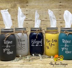 four painted mason jars with tissue dispensers