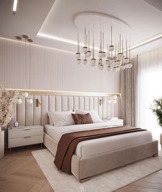 a large white bed sitting under a chandelier in a bedroom next to a window