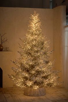 a white christmas tree with lights in a room