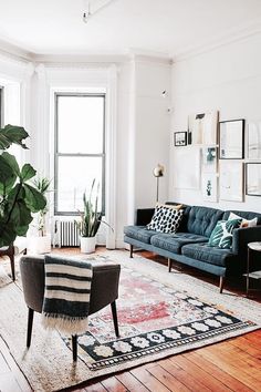 a living room filled with furniture and lots of plants