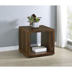 a small wooden table with a potted plant sitting on it's side shelf