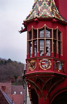 a tall red building with a clock on the top