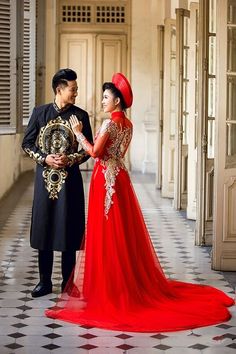 a man and woman in formal wear standing next to each other on a tiled floor