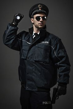 a police officer is holding his fist up in the air while posing for a photo