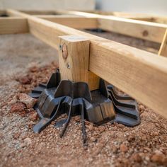 there are some tools that are laying on the ground next to each other in front of a wooden frame