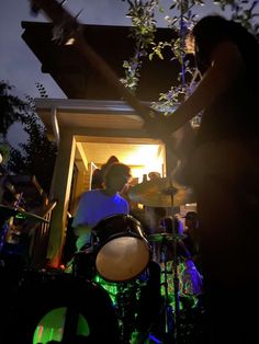 the band is playing outside in the dark