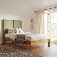 a bedroom with a bed, rug and window