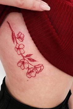 a woman's lower back tattoo with flowers on it