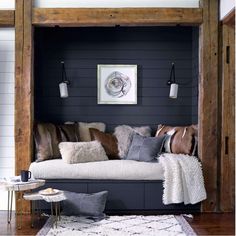 a living room filled with furniture and pillows