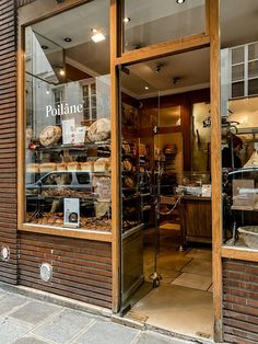 a store front with bread and pastries in the window