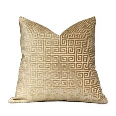 a gold pillow with an intricate design on the front and back, against a white background