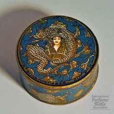 Muraour - Caresse d'Amour                     Specialty:Face Powder Boxes                    Type:powder                    Material(s):cardboard                    Designer/Maker:Henri Muraour et Cie                    Markings:Modele M                    Bottle Origin:Grasse, France                    Date or Era:1920's French Face, Grasse France, Vintage Boxes, Lipstick Case, Gold Dragon, Tin Containers