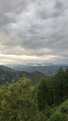 the sky is filled with clouds and some trees