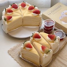 two slices of cake with strawberries on top and strawberry jam in the middle next to it