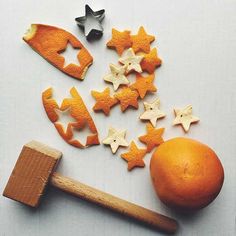 oranges, stars and hammer on a white surface with other items to make them look like they are made out of wood