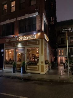 a small restaurant is lit up at night