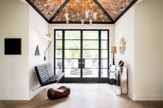 a large open room with a wooden ceiling and glass doors