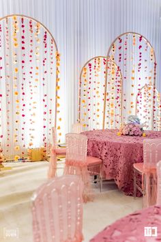 a banquet room with pink and yellow decorations