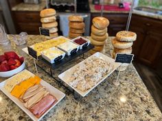 food is displayed on the counter at a hotel room breakfast buffet with donuts and fruit