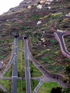 an aerial view of two roads on the side of a hill