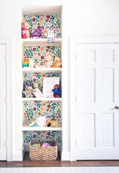 a white book shelf filled with lots of stuffed animals