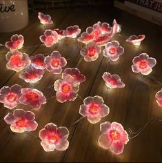 pink flowers are lit up with fairy lights