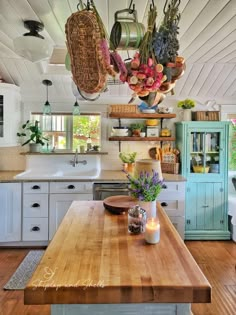 a kitchen with lots of hanging pots and pans