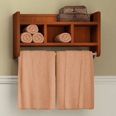 two towels are hanging on a shelf above the towel rack