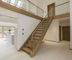 an open floor plan with stairs and glass railings