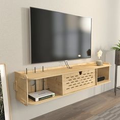 a flat screen tv mounted to the side of a wooden entertainment center in a living room