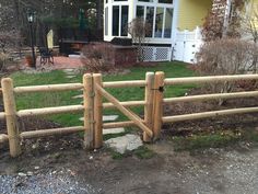 a wooden fence in front of a house