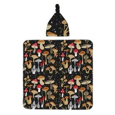 an oven mitt with mushrooms and stars on the back, hanging from a hook