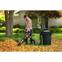 a man using a leaf blower to clean leaves